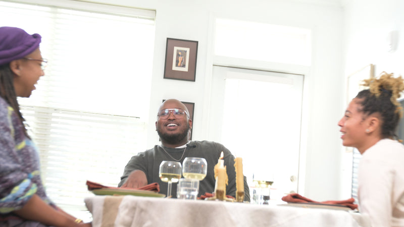 Jefferson at the table smiling in conversation with Ashleigh and Lay