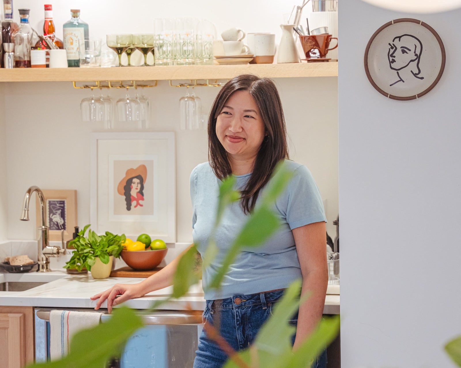 Ha standing and smiling in her kitchen