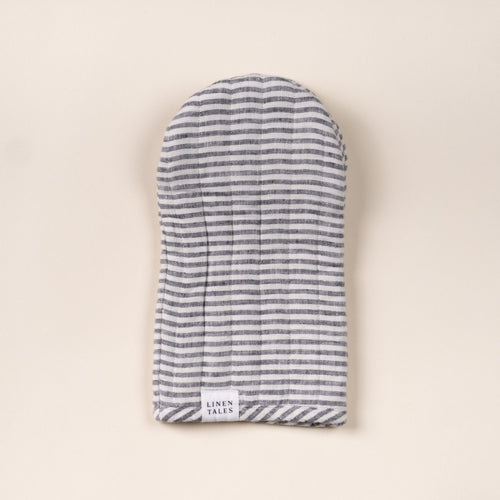Gray-and-white striped linen oven mitt with stitched channels and a small ‘Linen Tales’ label, laid flat on a light background.