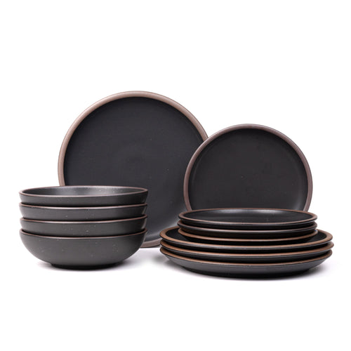 4 ceramic dinner plates, 4 side plates, and 4 shallow dinner bowls in a graphite black color with iron speckles and unglazed rims.
