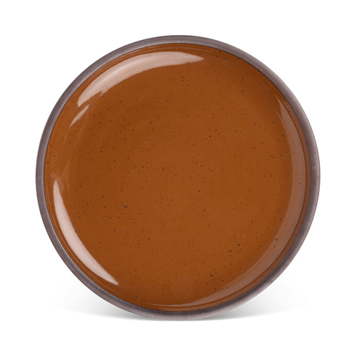 A large ceramic platter in a glossy caramel brown color featuring iron speckles and an unglazed rim.