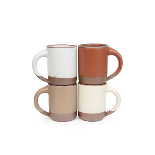 Four medium sized ceramic mugs with handles in a cool terracotta, warm off-white, cool white, and warm pale brown colors featuring iron speckles and unglazed rim