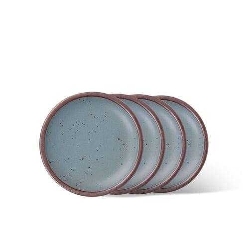 4 dessert sized ceramic plates in a blue-grey color featuring iron speckles and an unglazed rim.