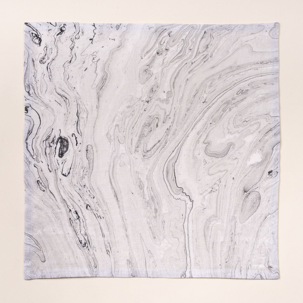 Gray marbled cloth napkin with swirling stone-like pattern on a light background.