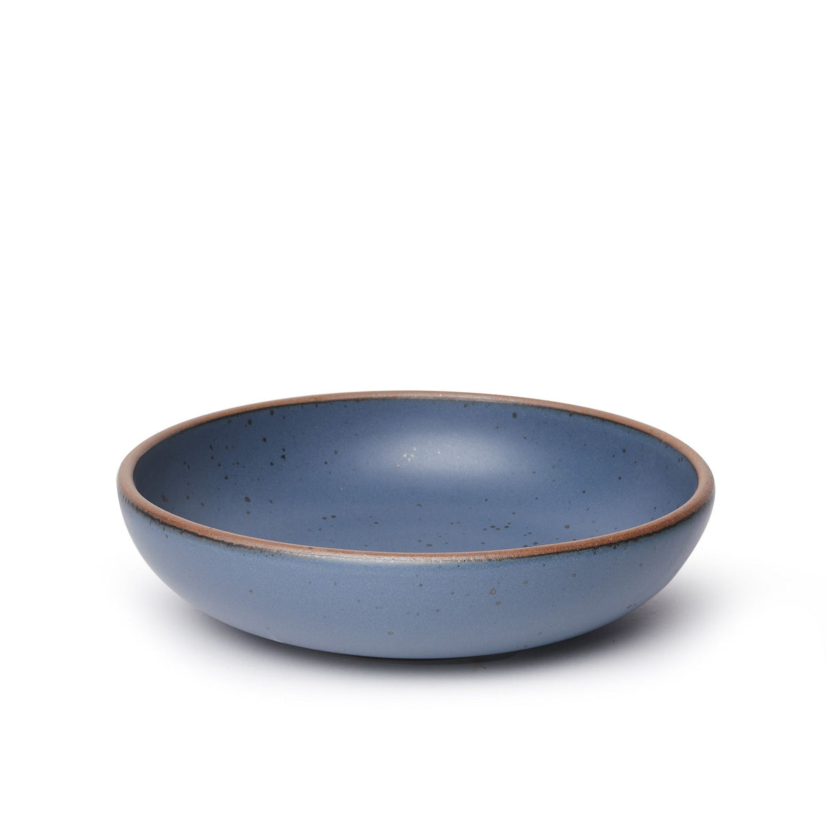 A large shallow serving ceramic bowl in a cool, medium blue color featuring iron speckles and an unglazed rim