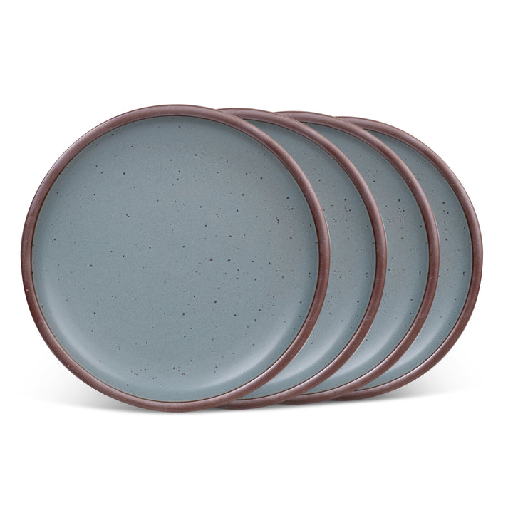 Set of four blue-grey ceramic dinner plates with unglazed rims on a white background