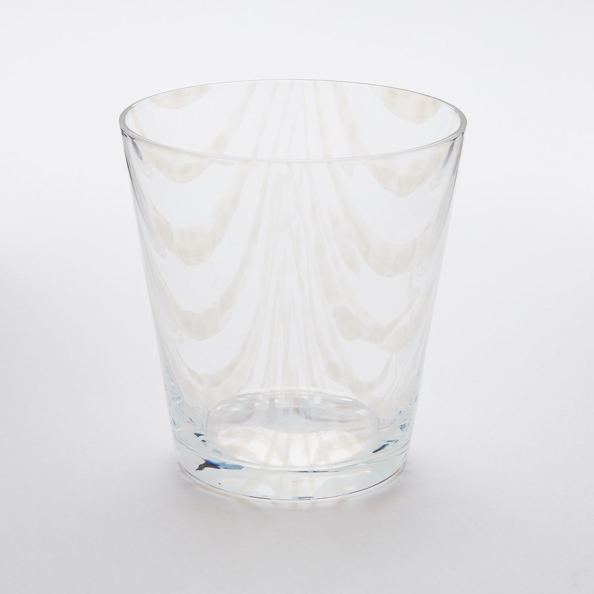 A short clear glass with a delicate ripple pattern