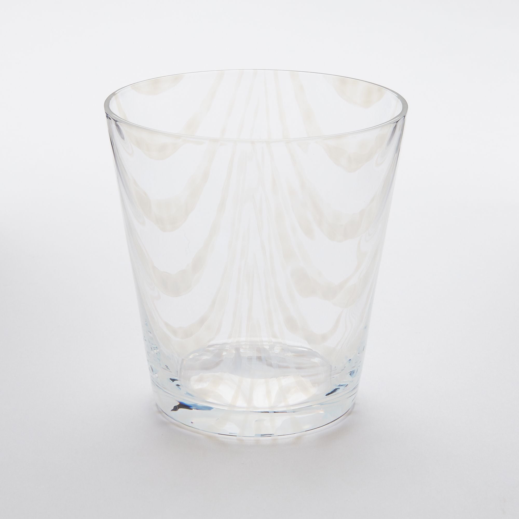 A short clear glass with a delicate ripple pattern