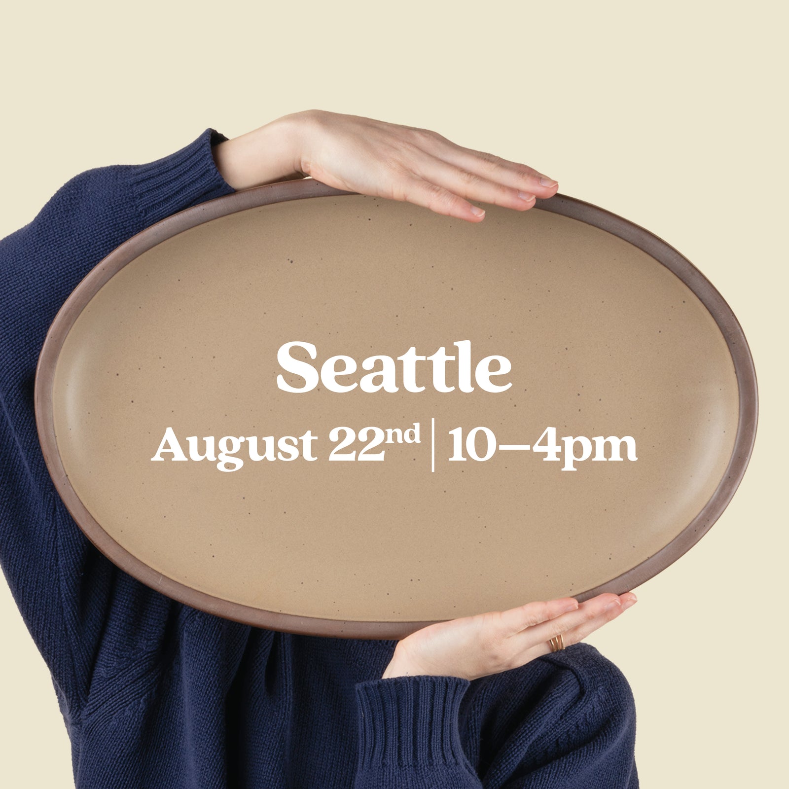 Person holds up a large oval platter with text overlay that reads "Seattle, August 22nd 10-4pm"