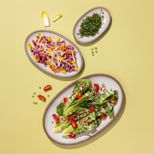 3 white oval platters in small, medium and large with varying vegetable ingredients.