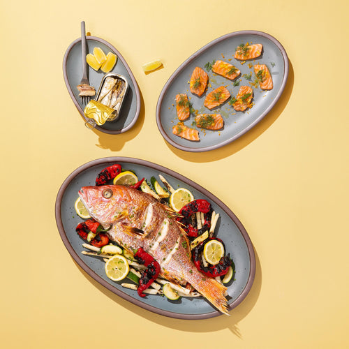 3 blue-gray oval platters in small, medium and large with varying sizes of fish dishes.