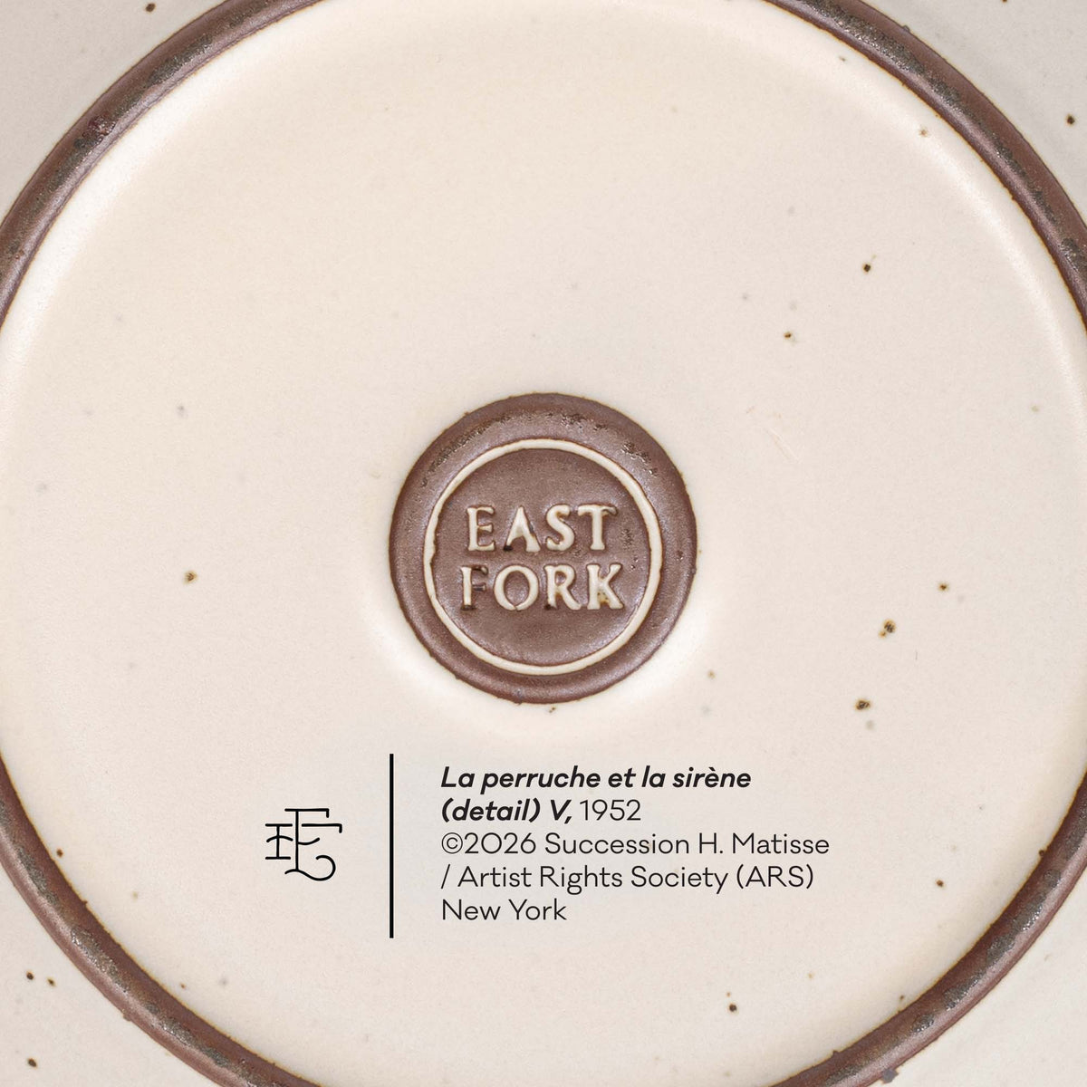 Close-up detail of a ceramic plate or dish base showing the brand mark 'EAST FORK' in a circular brown emblem, alongside printed text reading 'La perruche et la sirène (detail) V, 1952' and artist/copyright information.