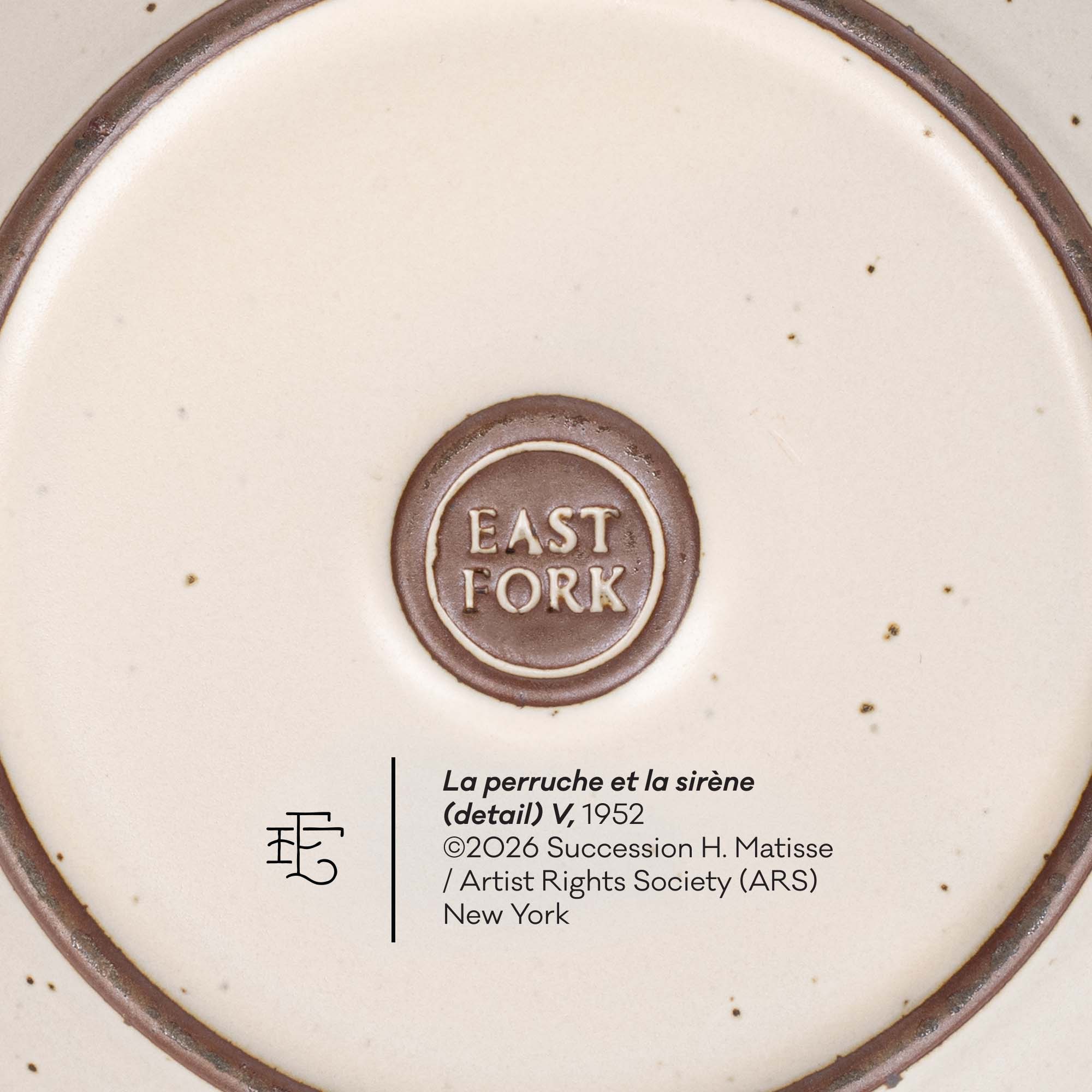 Close-up detail of a ceramic plate or dish base showing the brand mark 'EAST FORK' in a circular brown emblem, alongside printed text reading 'La perruche et la sirène (detail) V, 1952' and artist/copyright information.