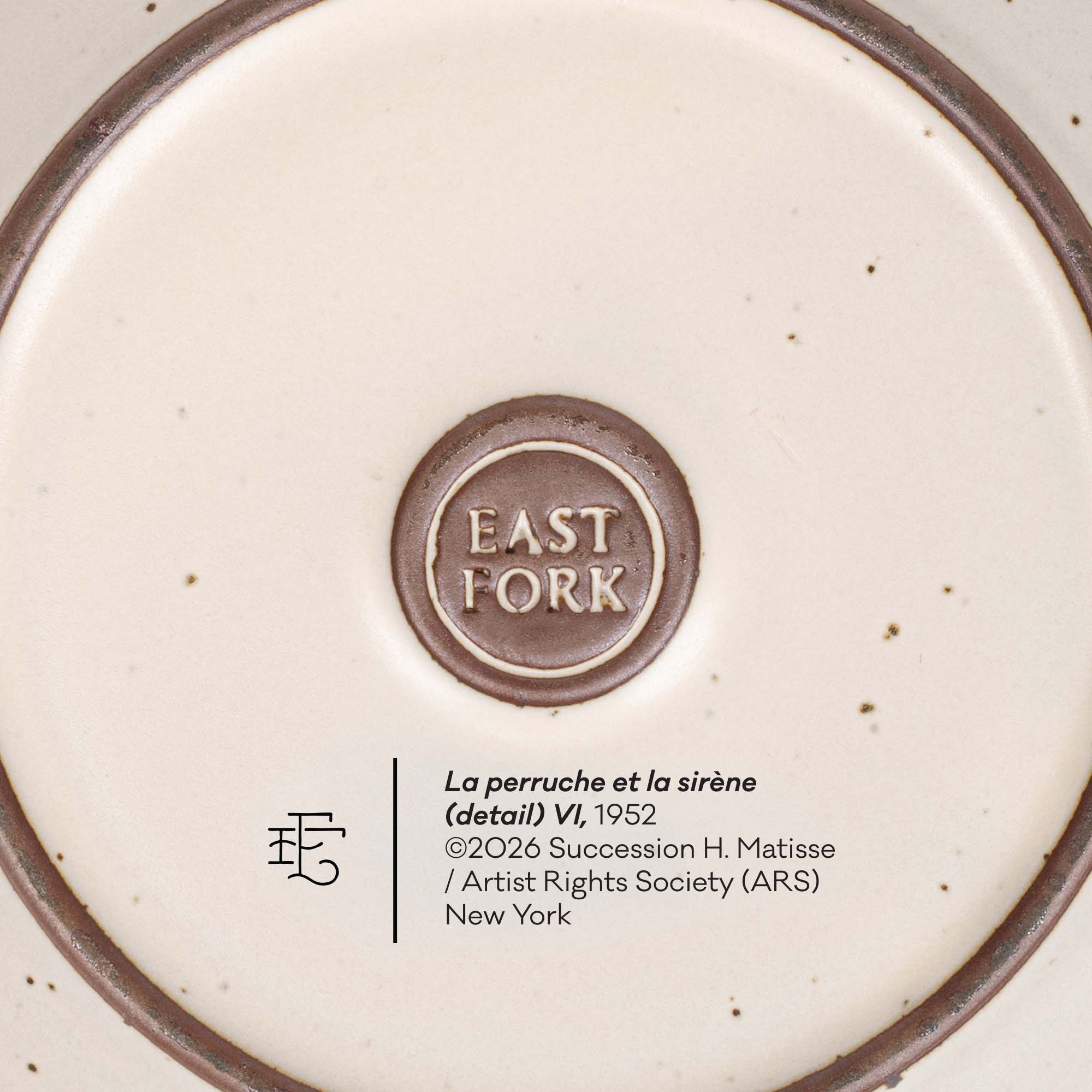 Close-up of the bottom of a ceramic plate or dish showing a circular brown logo reading EAST FORK in the center, with printed text below including 'La perruche et la sirène (detail) VI, 1952' and artist rights information.