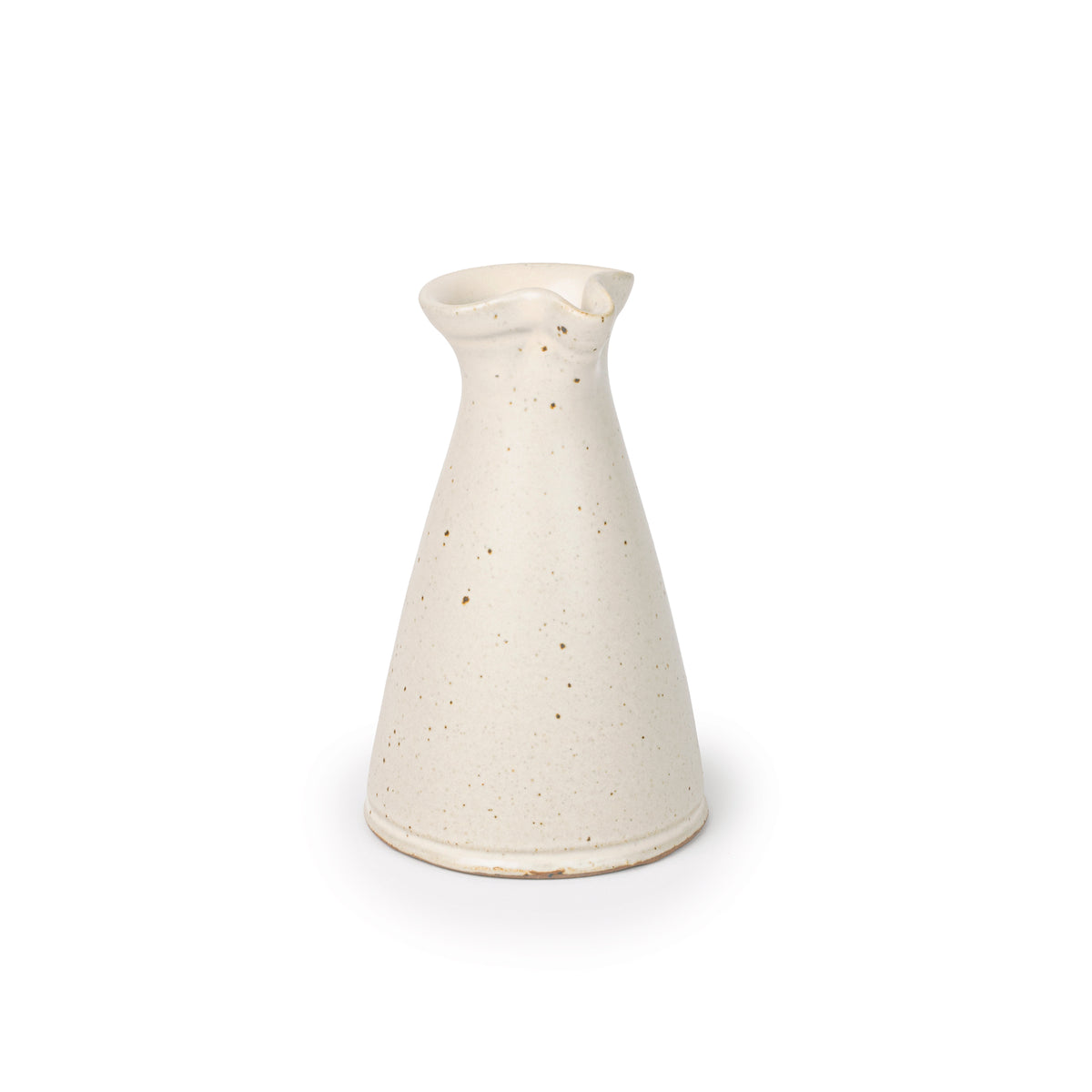 A small ceramic creamer with a narrow body and a subtle pouring spout at the top, in a warm off-white color, at an angle.