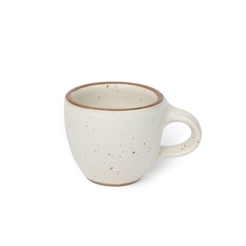 Small stoneware espresso cup with handle, in a warm off-white color with iron speckles.