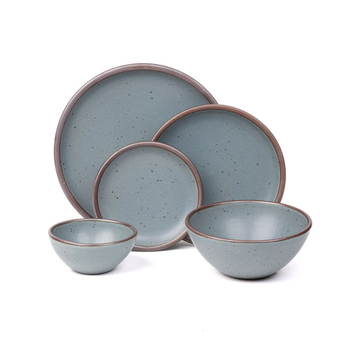 An ice cream bowl, soup bowl, cake plate, side plate and dinner plate in a blue-grey color featuring iron speckles