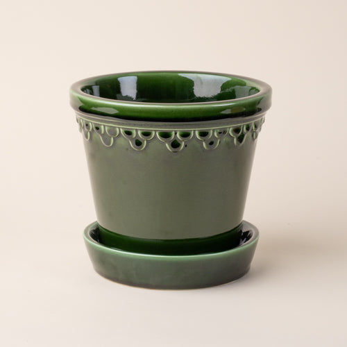 Large glossy green ceramic pot.