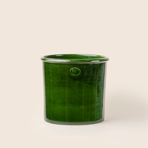 A very large glossy green ceramic planter.
