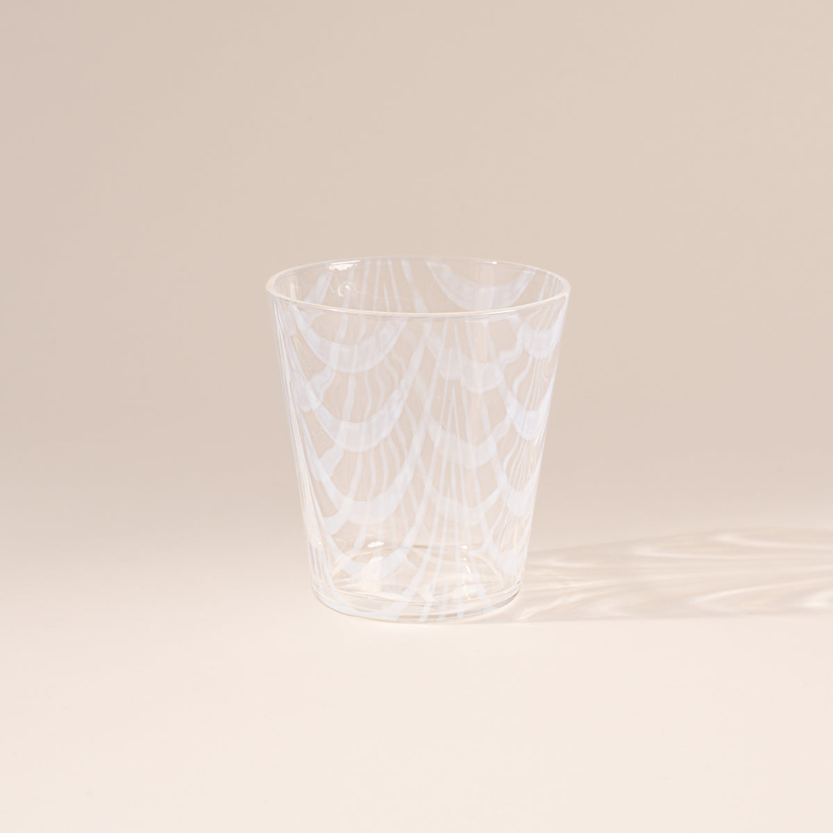 A short clear glass with a delicate ripple pattern