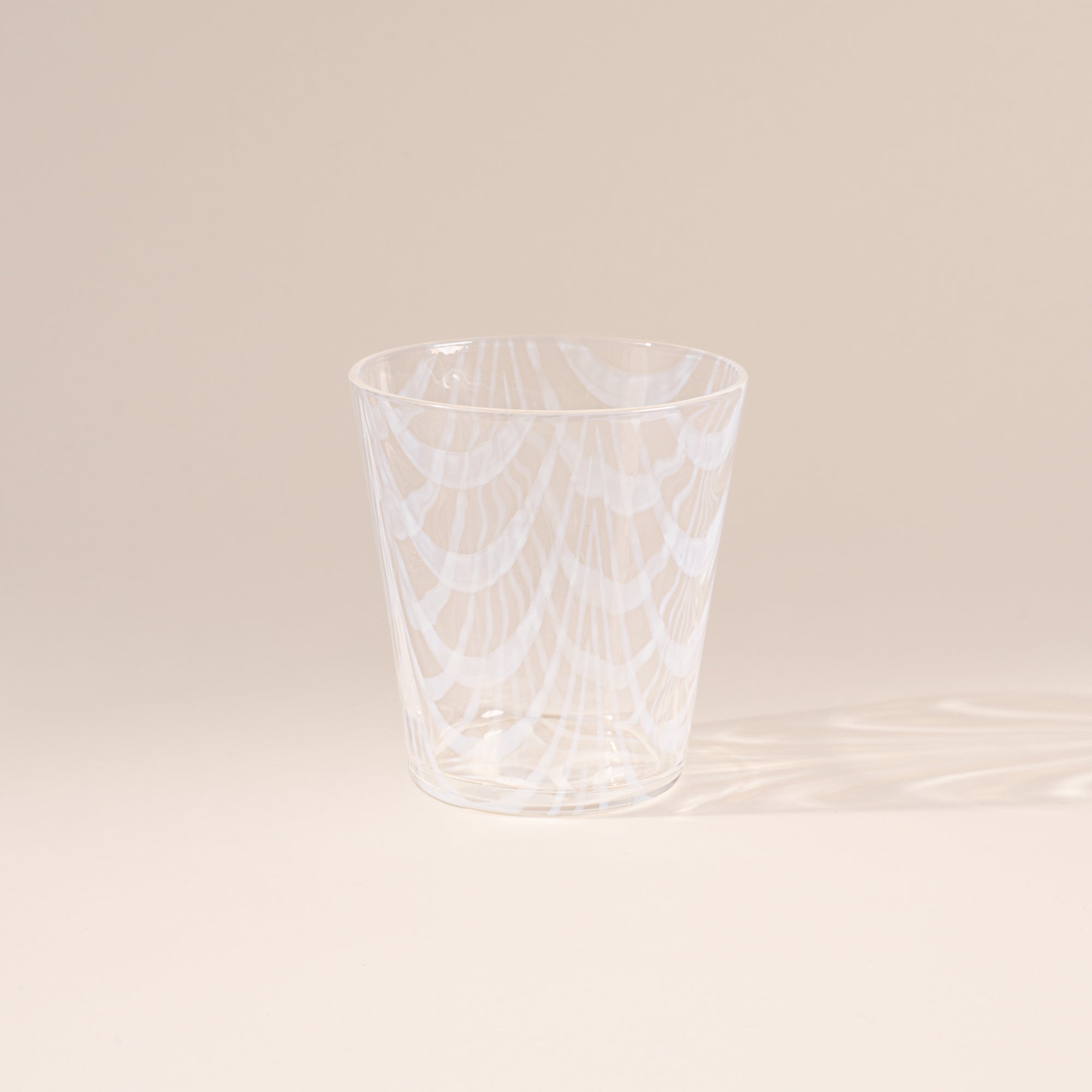 A short clear glass with a delicate ripple pattern