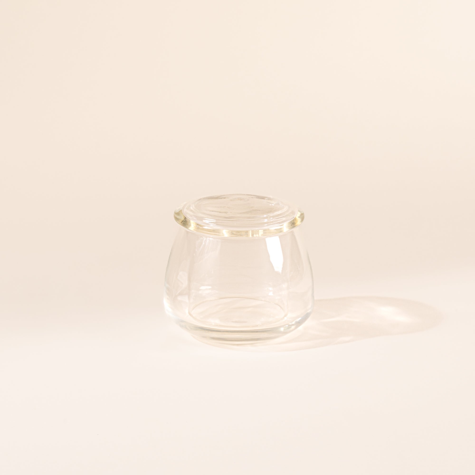 Clear glass butter keeper on white background