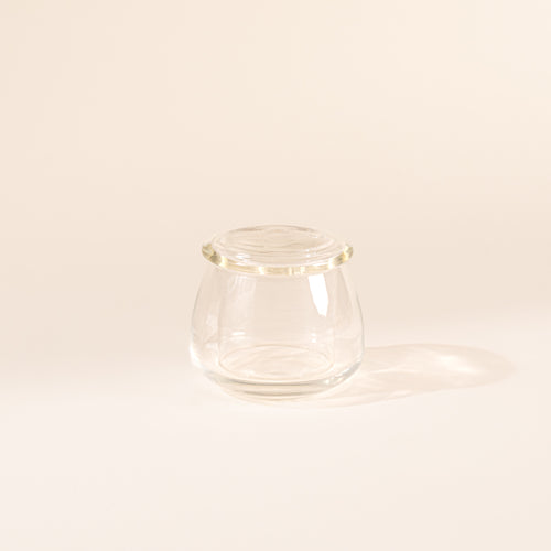 Clear glass butter keeper on white background