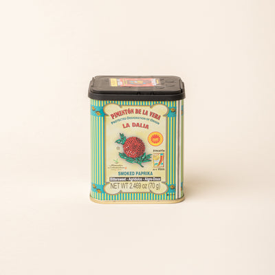 Tin of La Dalia smoked paprika with a black lid on a plain white background.