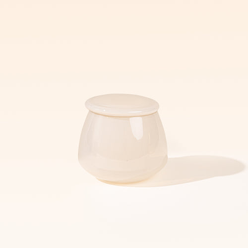 Cream clear glass butter keeper on white background