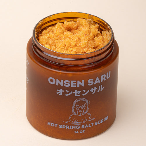 An open amber jar of Onsen Saru Hot Spring Salt Scrub