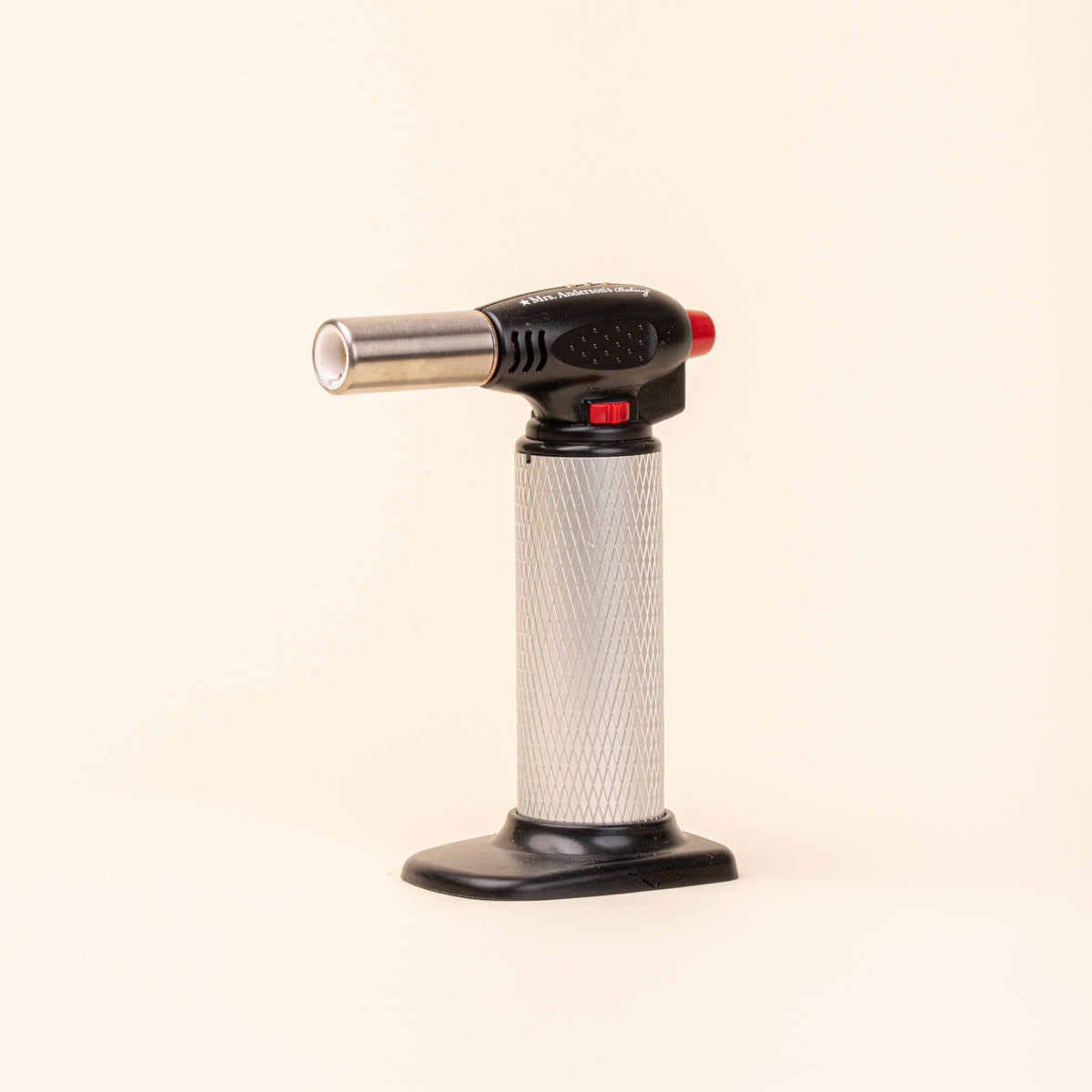 Black and silver culinary torch with red controls on a light background.