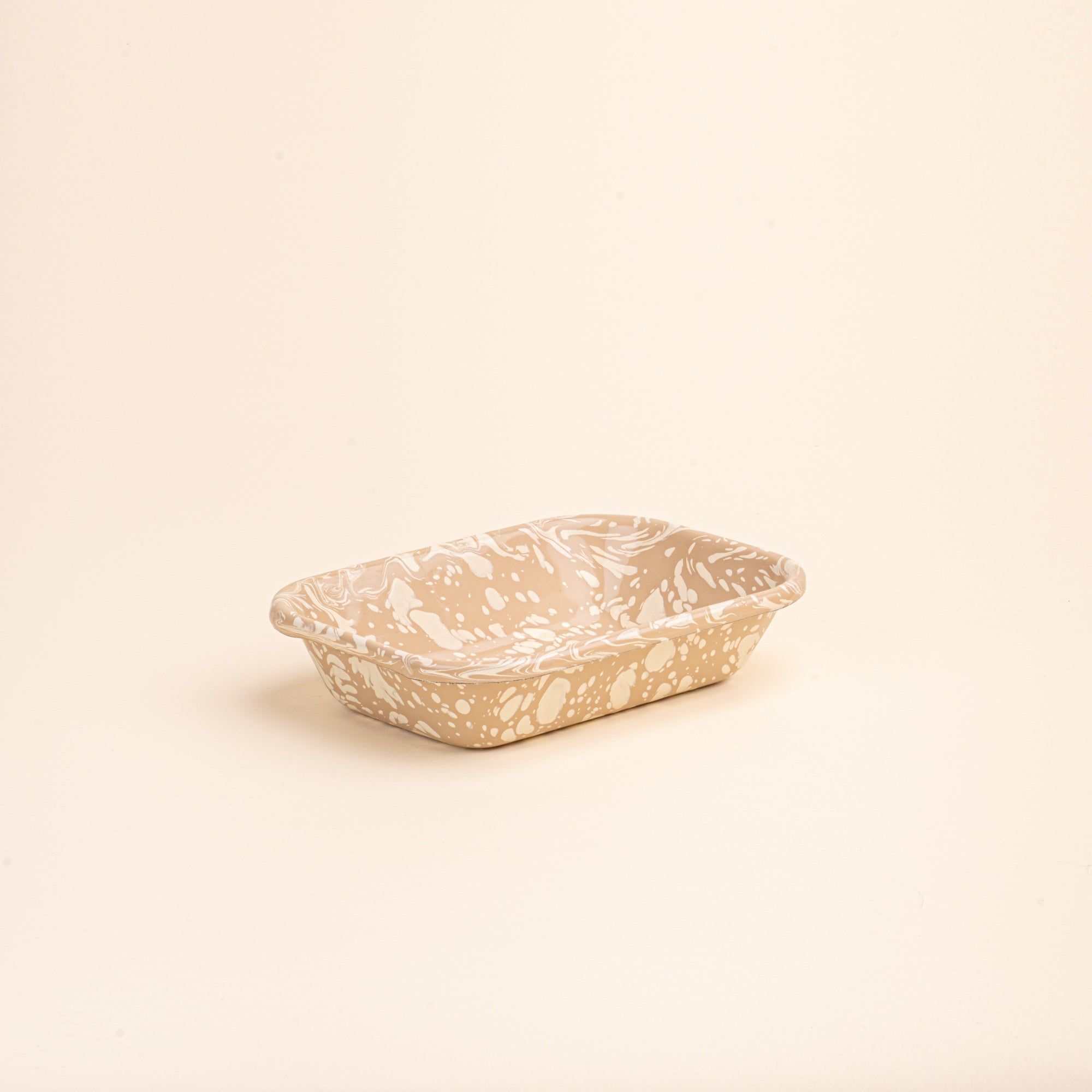 Small rectangular baking dish in a neutral tan color with off-white splattered pattern.