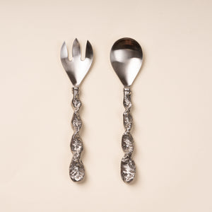 Stainless steel salad serving fork and spoon with textured twisted handles.