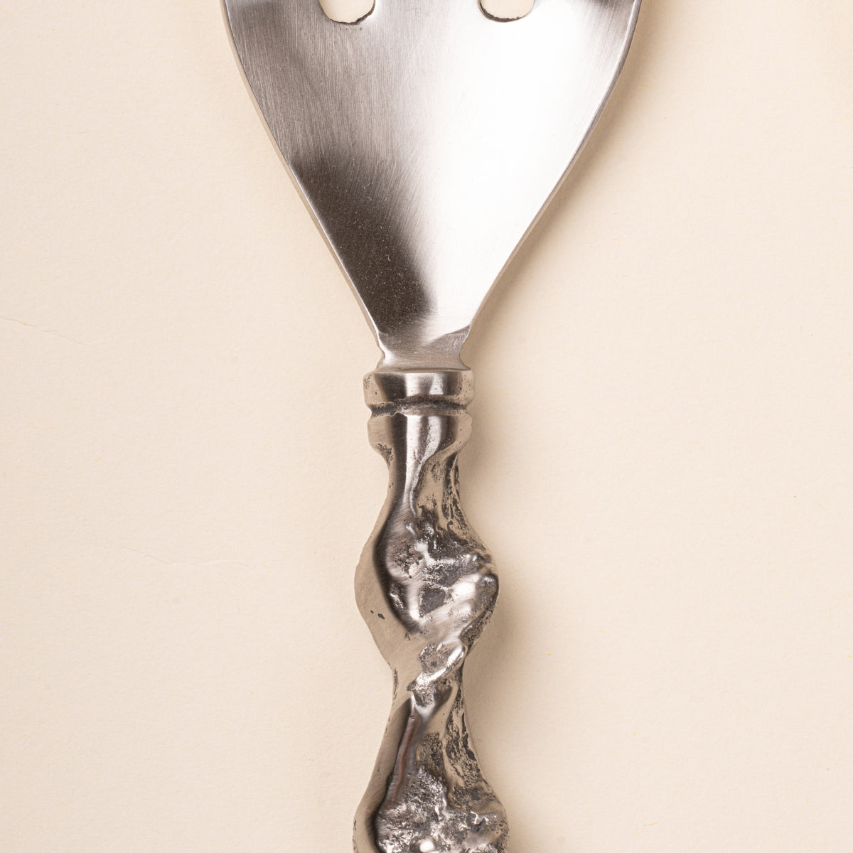Closeup of a stainless steel fork textured twisted handle