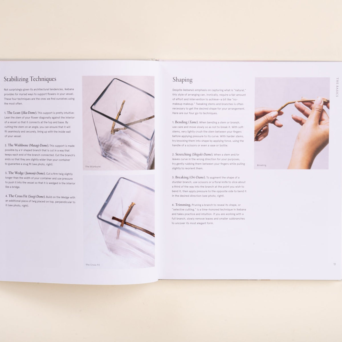 An open book showing two instructional pages with text and small photos related to sculpting or crafting, photographed from above on a light beige background.