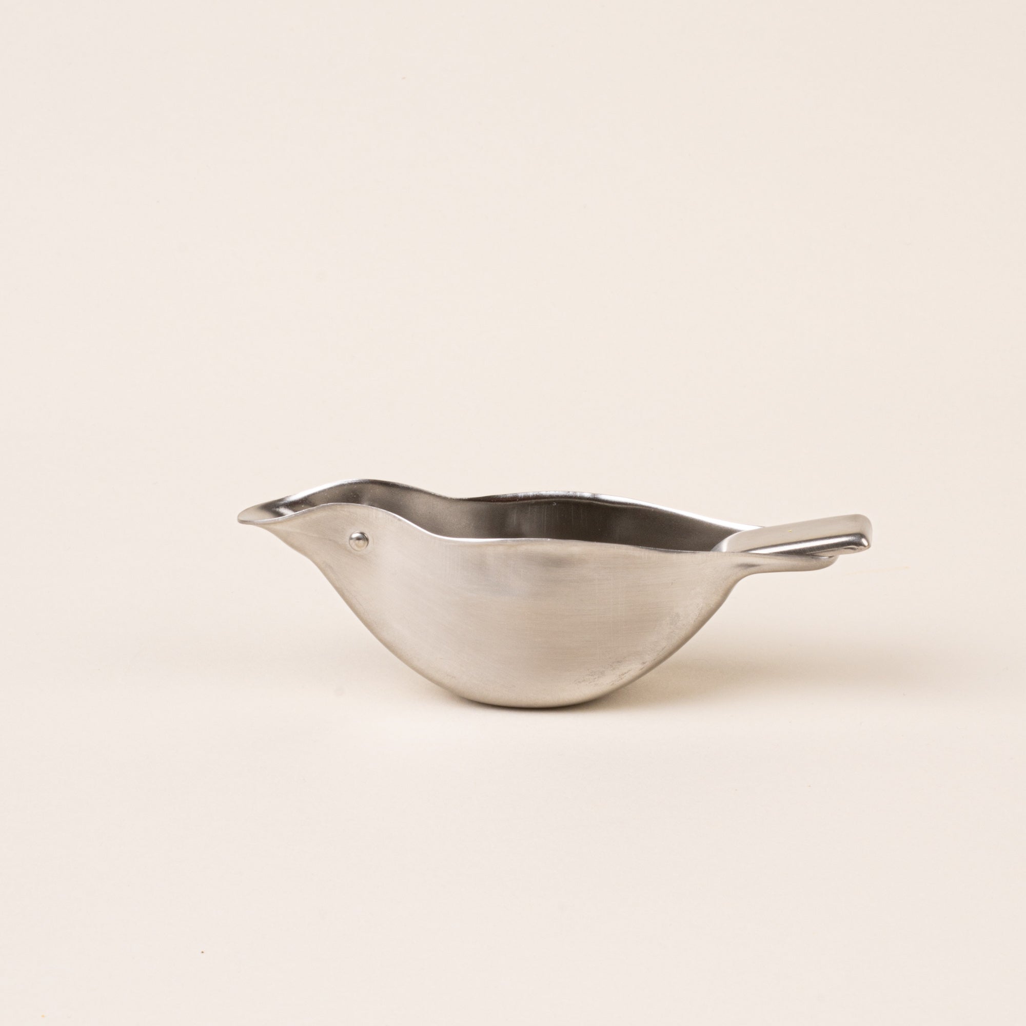 A sculptural stainless-steel lemon squeezer with a bird-like silhouette.