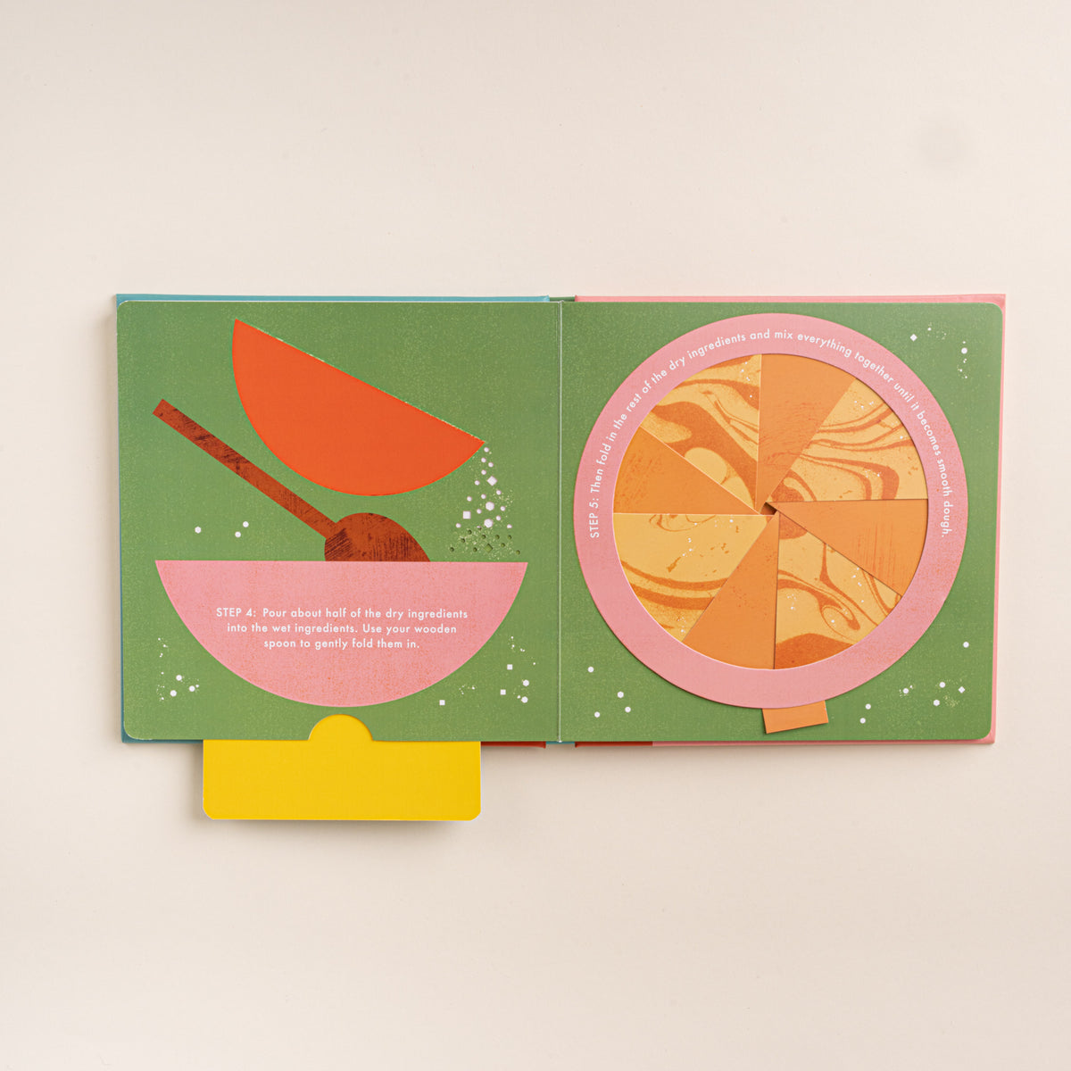 Open interactive cookie recipe book showing illustrated mixing steps with a bowl, spoon, and rotating dough wheel.
