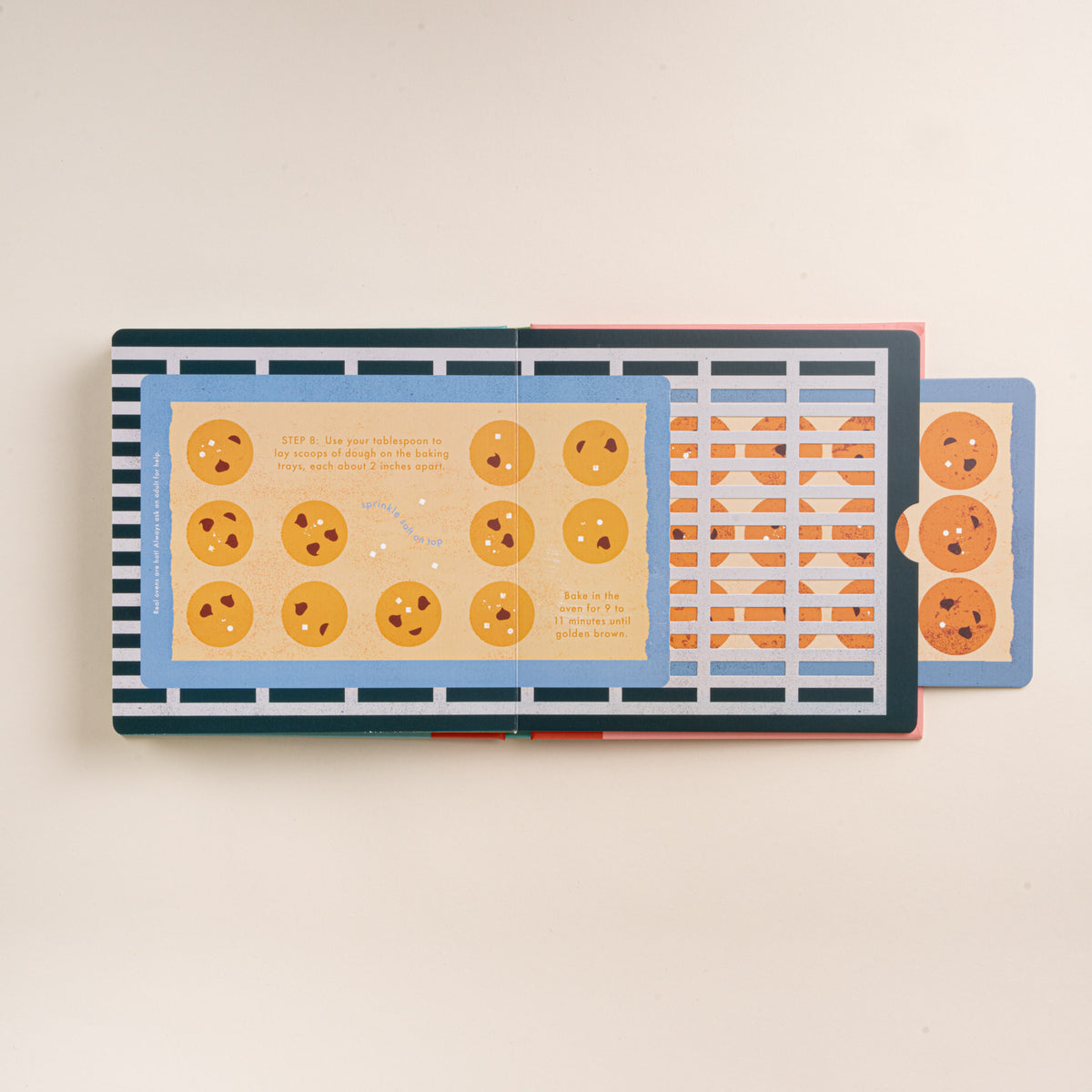 Open interactive cookie recipe book showing illustrated cookies on baking trays with a pull-out tab.
