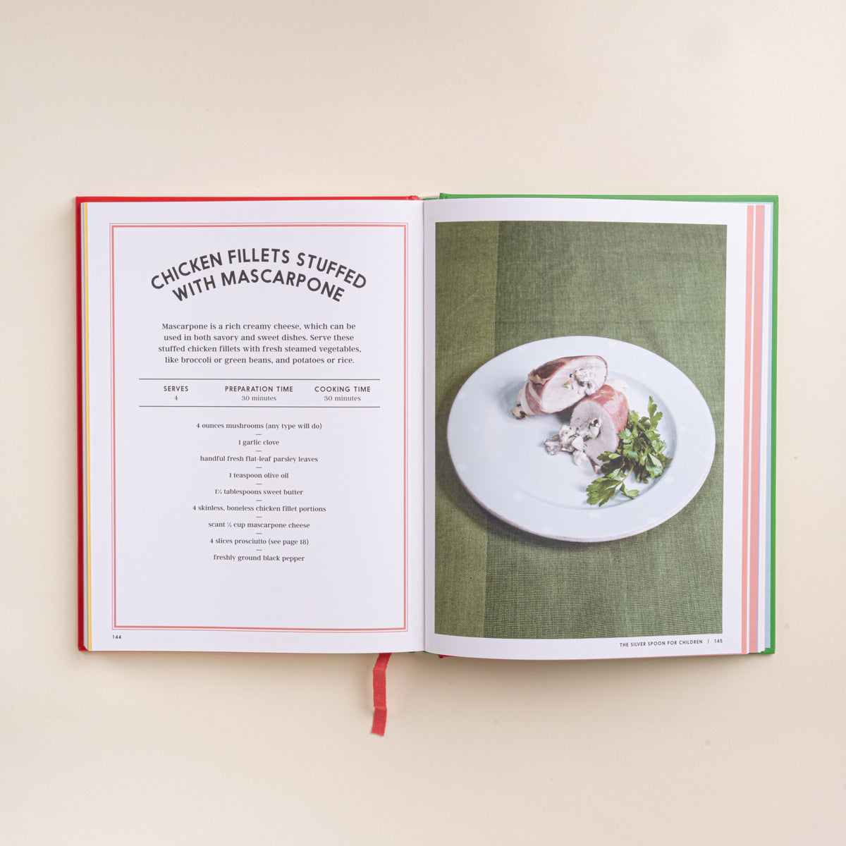 Open children’s cookbook showing a chicken fillets stuffed with mascarpone recipe and plated dish.