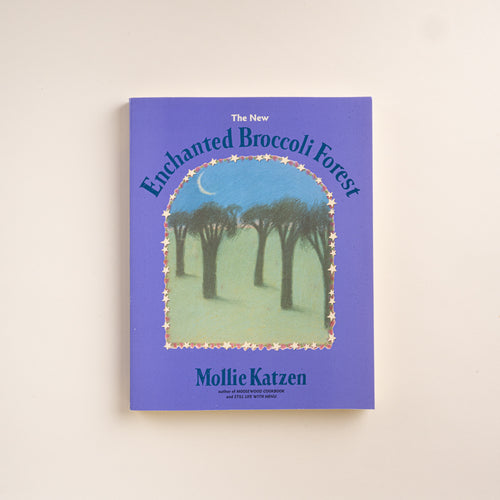 Purple cover of The New Enchanted Broccoli Forest cookbook by Mollie Katzen, featuring an illustrated forest scene.