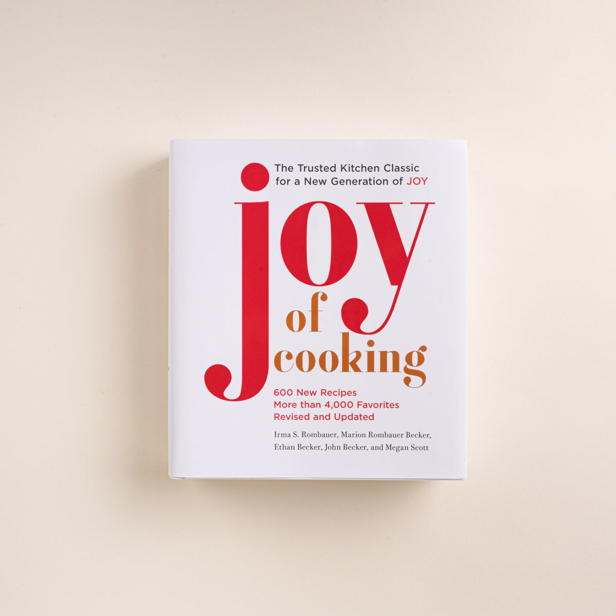 White cover of the Joy of Cooking cookbook with large red and orange title text.