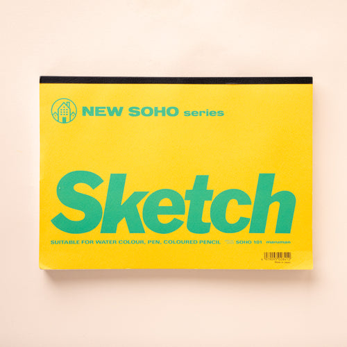 A large yellow sketchpad with green text that reads 'Sketch'