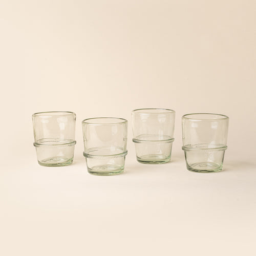Set of four clear short recycled glass tumblers with a ridged band detail.