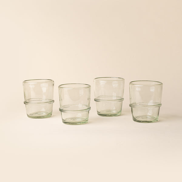 Set of four clear short recycled glass tumblers with a ridged band detail.