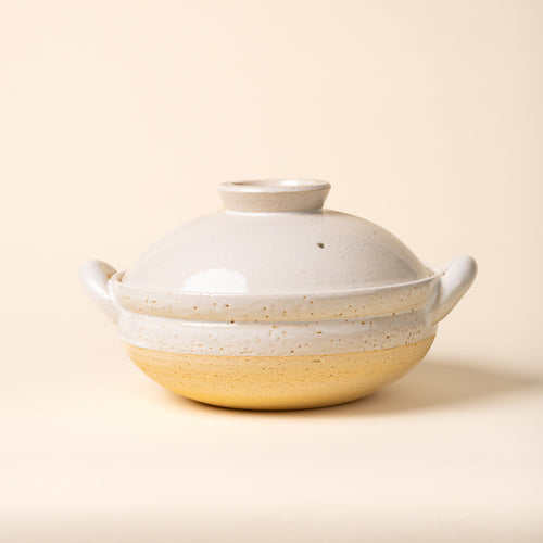 White ceramic lidded donabe steamer with side handles