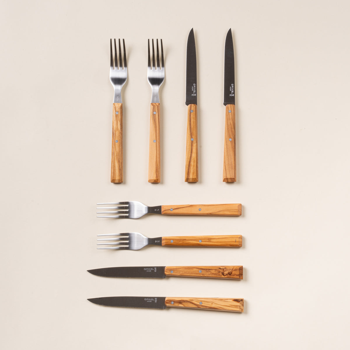 Set of 8 Opinel table knives and forks with wooden handles.