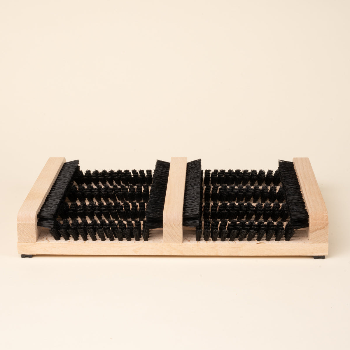Wooden boot and shoe cleaning brush with multiple bristle sections.