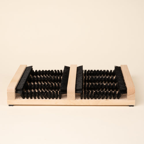 Wooden boot and shoe cleaning brush with multiple bristle sections.