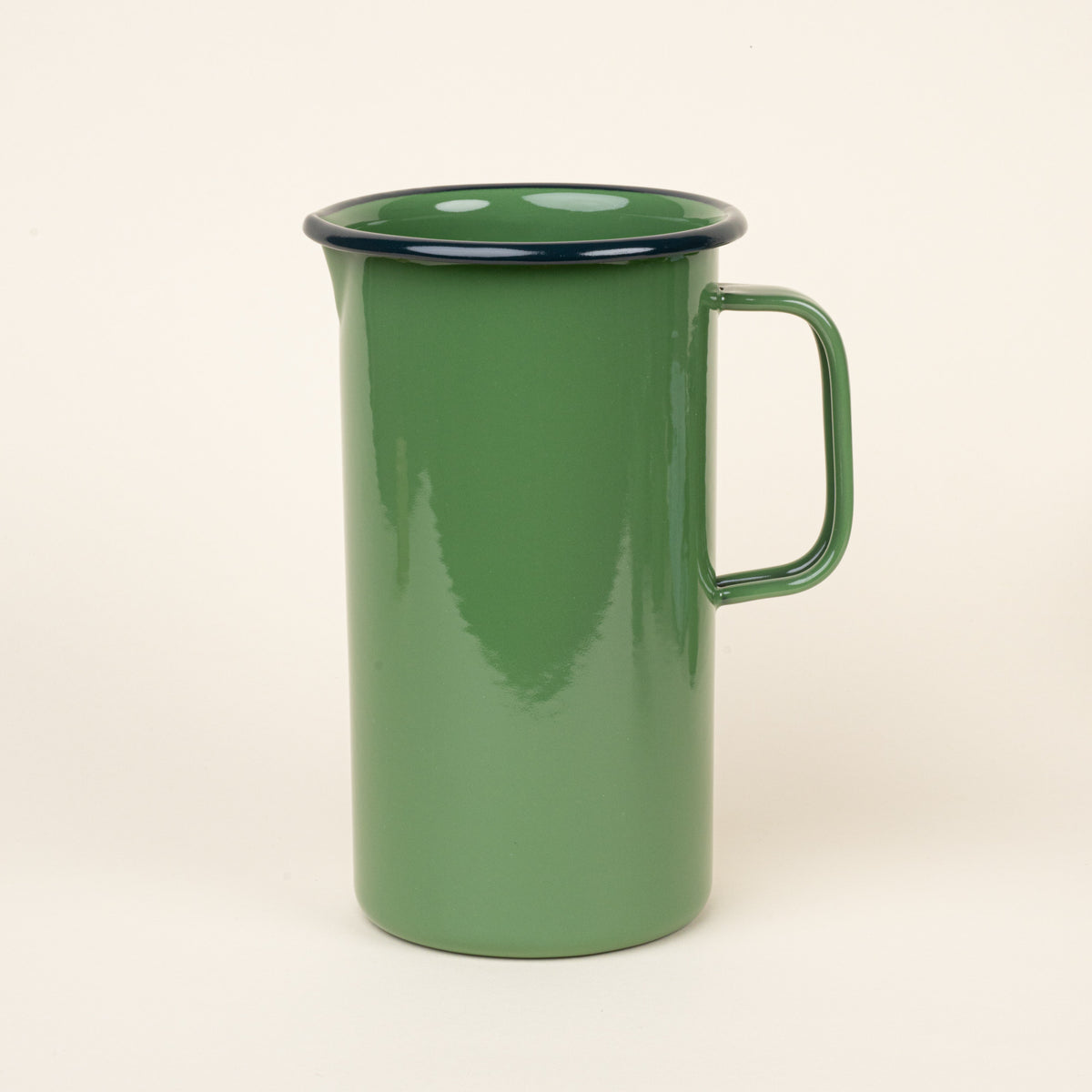 A large enamel pitcher with handle in a green color with a dark rim.