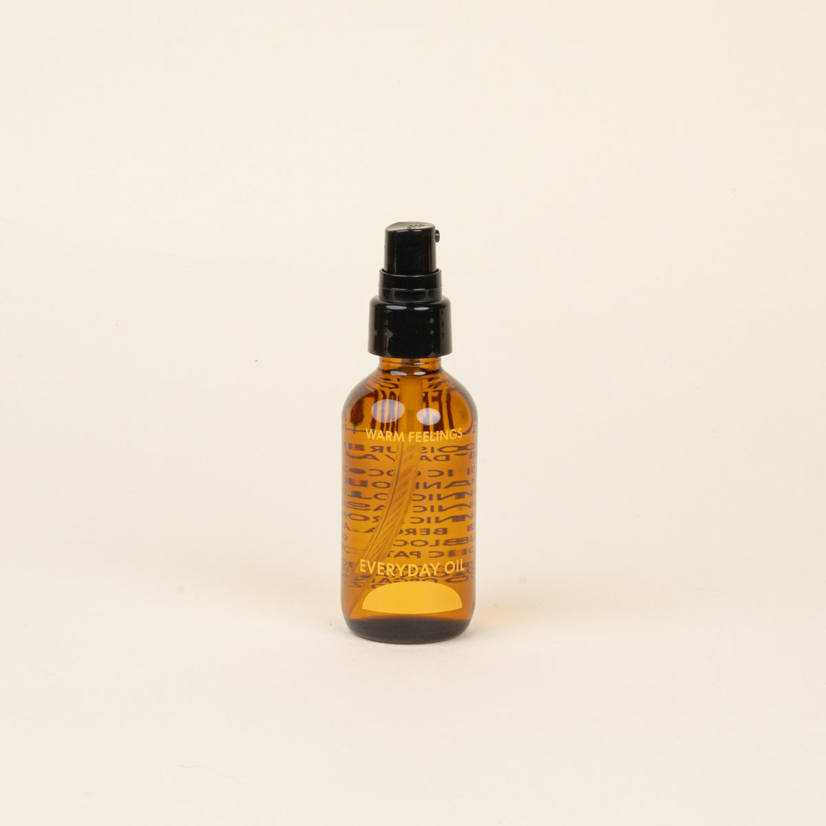 Amber glass bottle with black cap and label that reads 'Warm Feelings Everyday Oil' on a beige background.